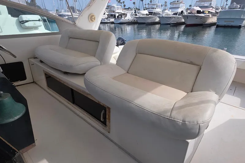 Interior seating of 1988 Sea Ray 460 Express Cruiser at marina.