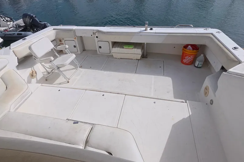 1988 Sea Ray 460 Express Cruiser deck with seating, storage, and cleaning supplies.