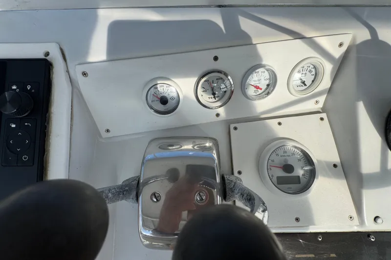 1984 Blackfin 32 Flybridge dashboard with gauges and controls in sunlight.