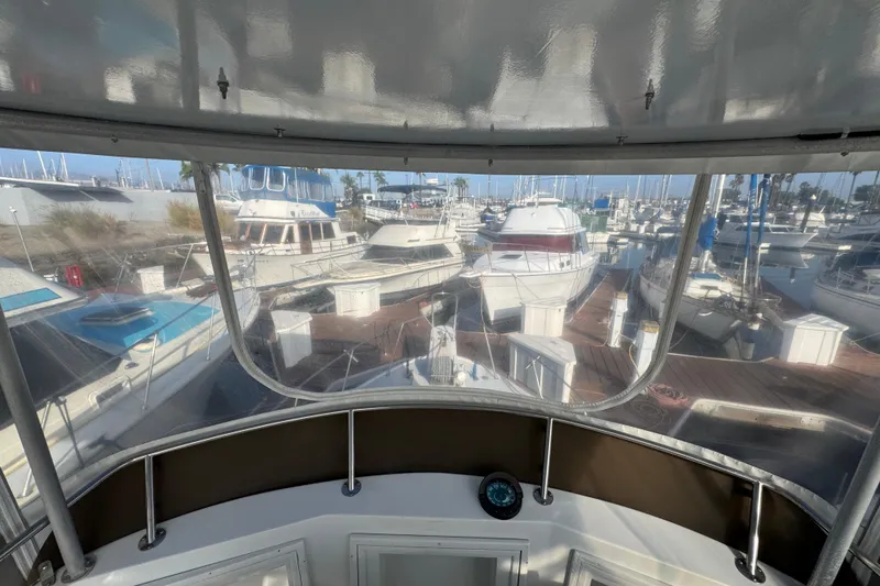 View from 1984 Blackfin 32 Flybridge overlooking marina with multiple docked boats.