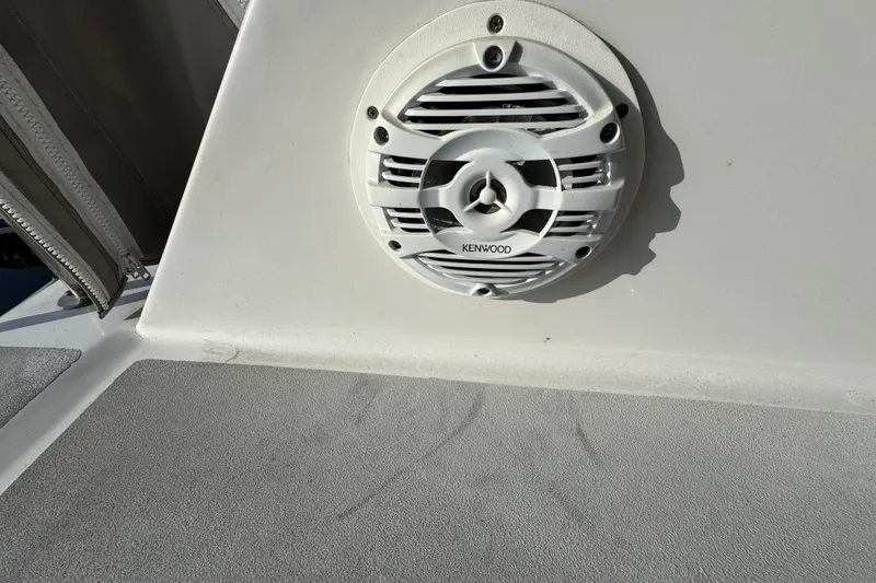 Kenwood speaker on 1984 Blackfin 32 Flybridge boat, mounted on white surface.