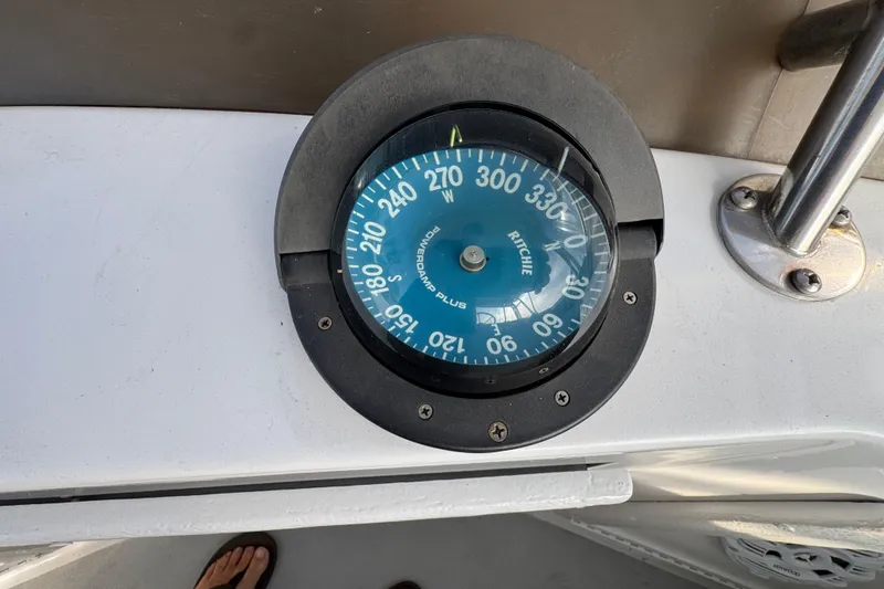 Compass on 1984 Blackfin 32 Flybridge boat, showing direction and navigation details.