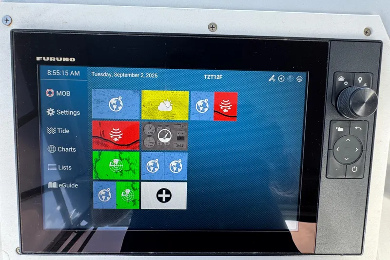 Touchscreen display on a 1984 Blackfin 32 Flybridge, showing navigation and weather apps.