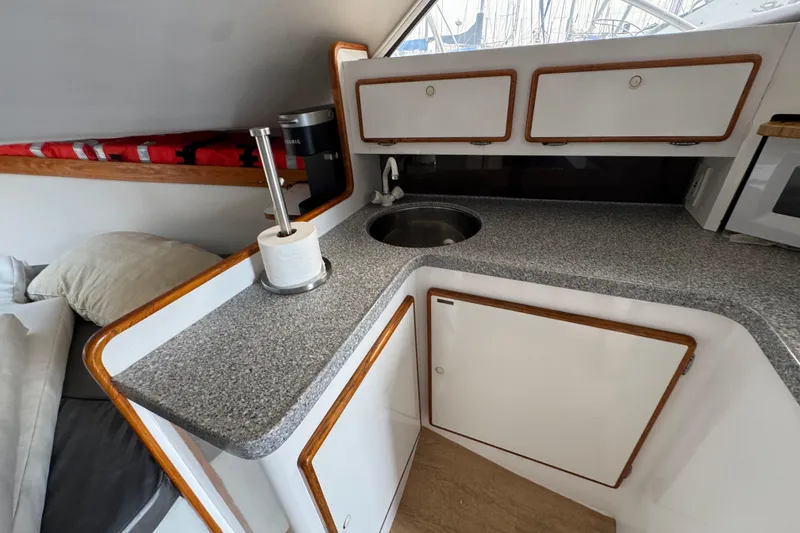1984 Blackfin 32 Flybridge interior kitchen with sink, cabinets, and countertop.
