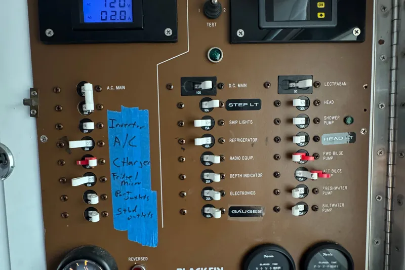 Electrical panel of a 1984 Blackfin 32 Flybridge boat with labeled switches and gauges.