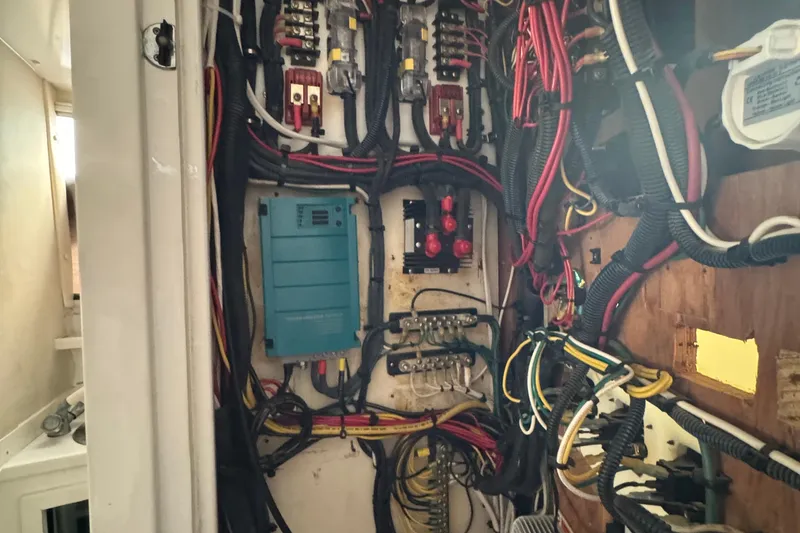 Electrical wiring and components inside a 1984 Blackfin 32 Flybridge boat.