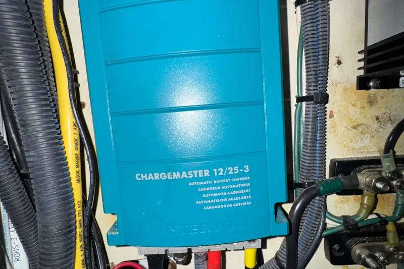Blue battery charger in 1984 Blackfin 32 Flybridge boat engine compartment.