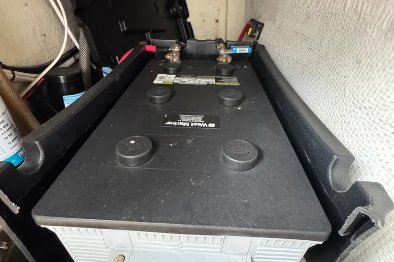Battery compartment of a 1984 Blackfin 32 Flybridge boat, featuring wiring and components.
