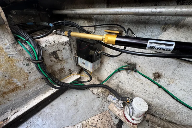 1984 Blackfin 32 Flybridge engine compartment with hydraulic steering system and wiring.