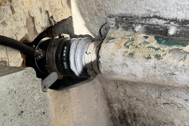 Close-up of a 1984 Blackfin 32 Flybridge boat's worn-out pipe and fittings.