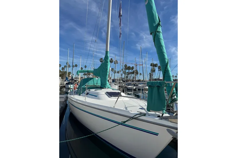 1997 Catalina 36 MkII sailboat docked in marina with clear blue sky.