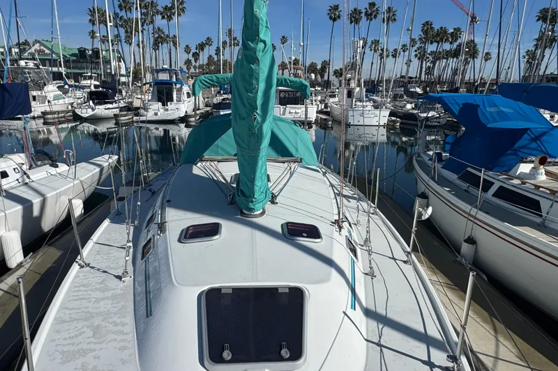 1997 Catalina 36 MkII sailboat docked in a marina, surrounded by other boats.