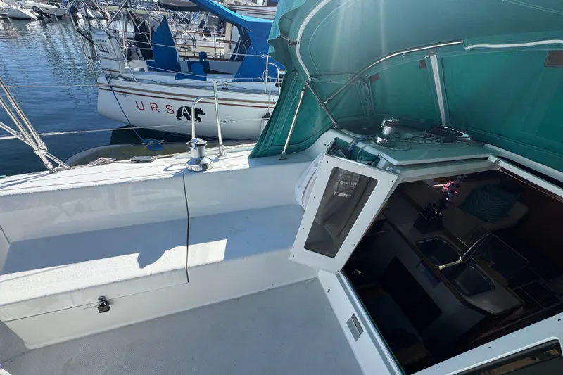 1997 Catalina 36 MkII sailboat cockpit with green canopy and marina view.