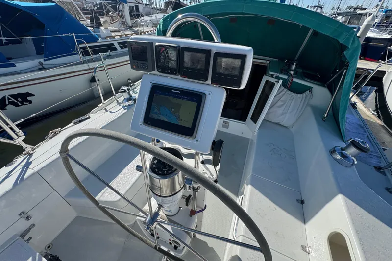 Cockpit of 1997 Catalina 36 MkII sailboat with navigation equipment and steering wheel.