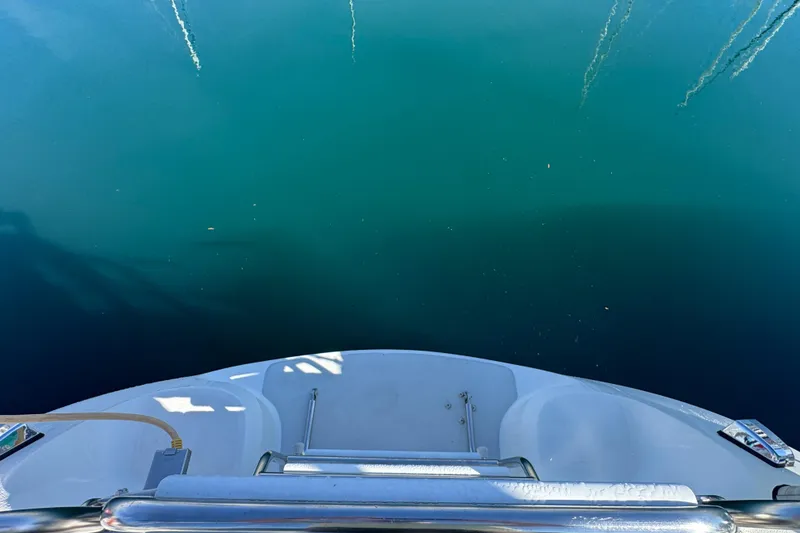 View from the stern of a 1997 Catalina 36 MkII sailboat over calm water.