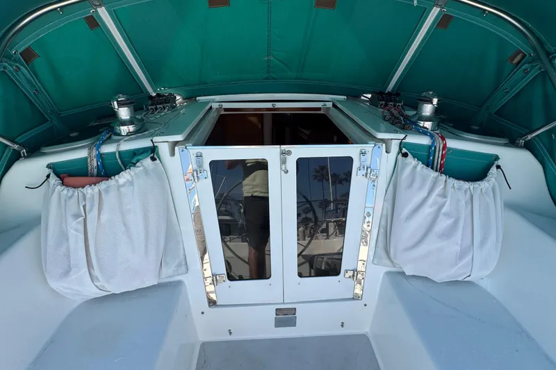 1997 Catalina 36 MkII sailboat cockpit with teal canopy and white curtains.