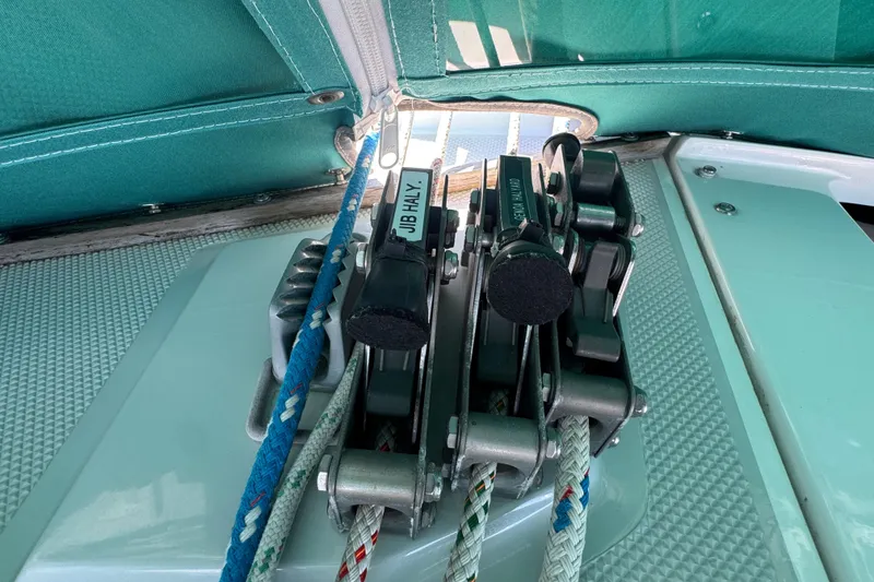 Close-up of Catalina 36 MkII 1997 sailboat rigging and ropes under green canopy.