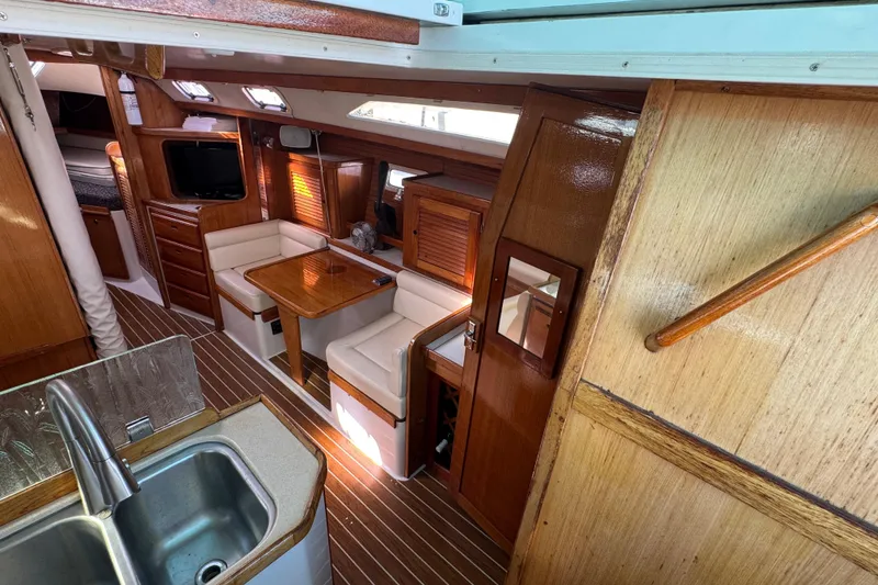 Interior of 1997 Catalina 36 MkII sailboat with wood finish and cozy seating area.