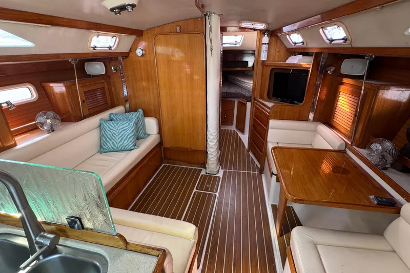 Interior of a 1997 Catalina 36 MkII sailboat with wood finish and cozy seating.