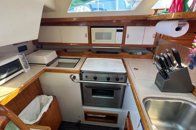 1997 Catalina 36 MkII yacht kitchen with stove, microwave, and sink.