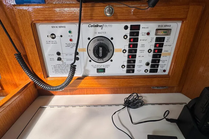 Electrical control panel of a 1997 Catalina 36 MkII yacht, featuring various switches and indicators.