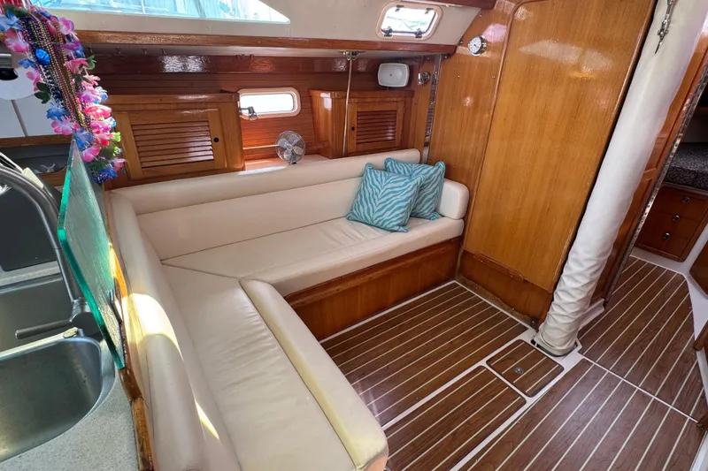 Interior of 1997 Catalina 36 MkII sailboat with wooden finish and cozy seating area.