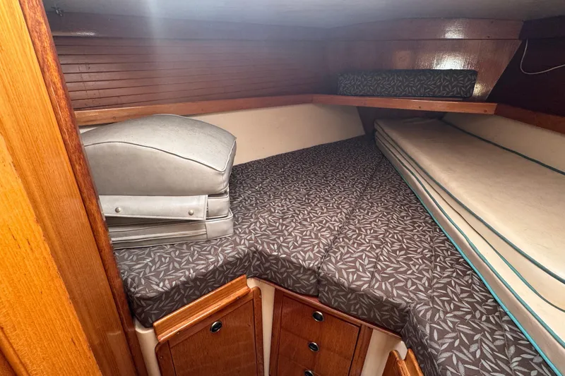 Cozy cabin interior of 1997 Catalina 36 MkII sailboat with patterned bedding.