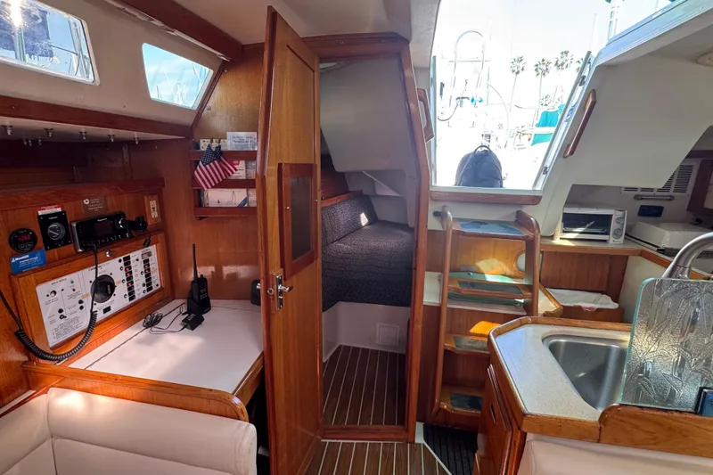 Interior of a 1997 Catalina 36 MkII sailboat, featuring navigation station and cozy cabin.