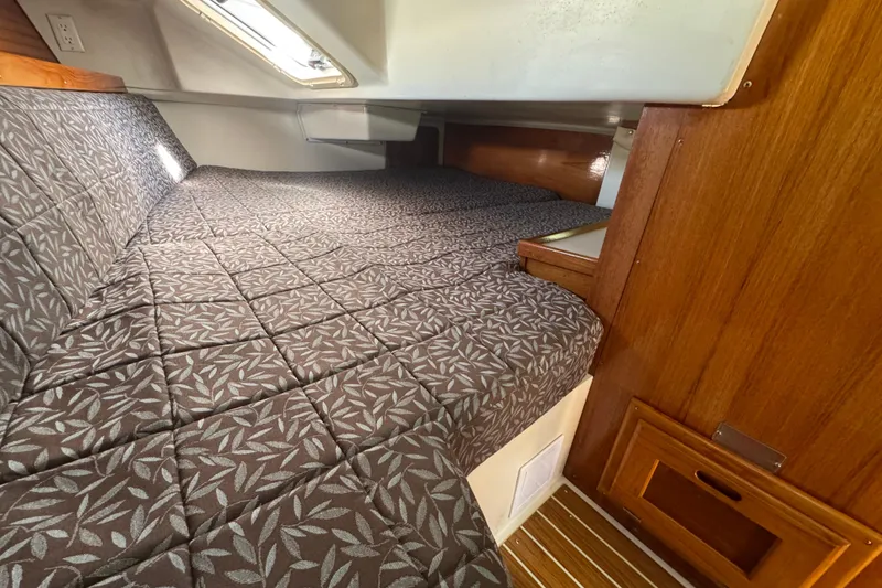 Cozy cabin interior of 1997 Catalina 36 MkII sailboat with patterned bedding.