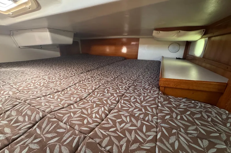 Interior cabin of a 1997 Catalina 36 MkII sailboat with patterned bedding.