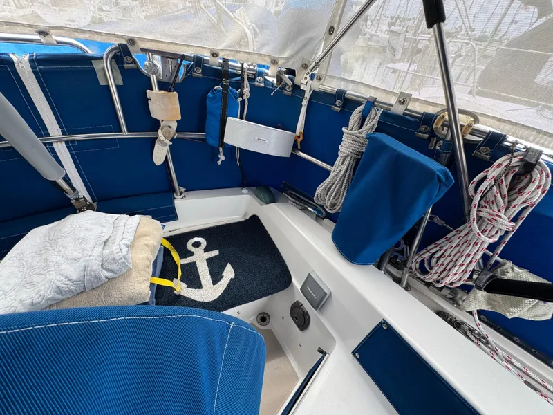 1985 Catalina 36 MK1 sailboat cockpit with blue upholstery and nautical-themed decor.