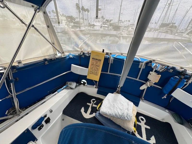 Interior of a 1985 Catalina 36 MK1 sailboat with blue upholstery and nautical decor.