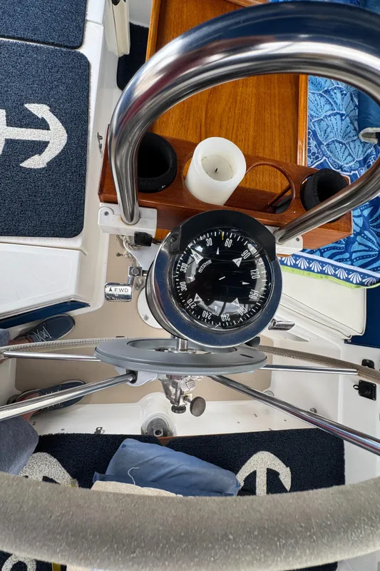 Compass and helm of 1985 Catalina 36 MK1 sailboat, featuring nautical decor.