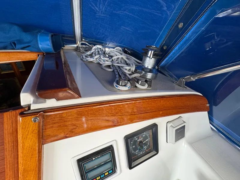 Cockpit of 1985 Catalina 36 MK1 sailboat with winch, ropes, and navigation instruments.