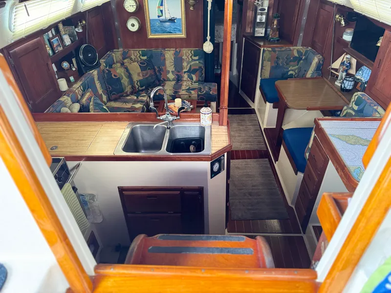 Interior of 1985 Catalina 36 MK1 sailboat with cozy seating and kitchen area.