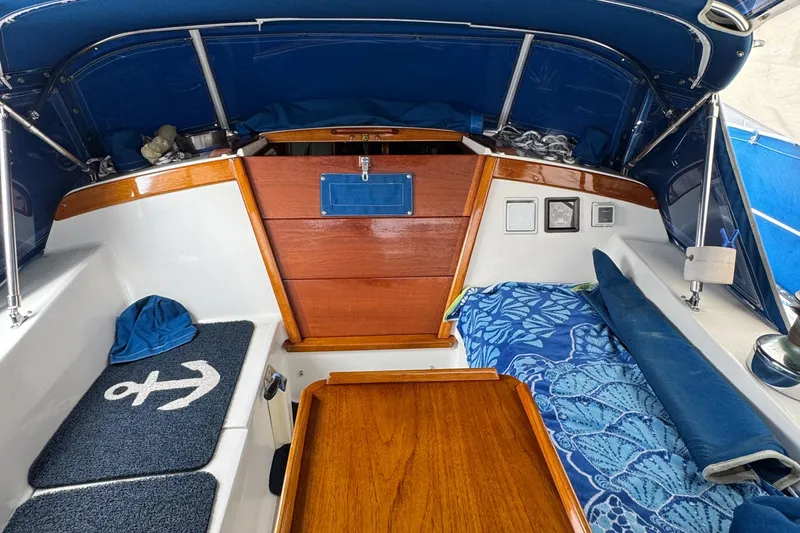 Interior of 1985 Catalina 36 MK1 sailboat with blue and wood accents.