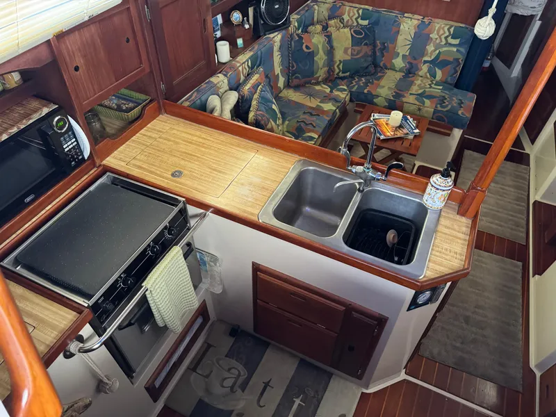 Interior of 1985 Catalina 36 MK1 sailboat with kitchen and seating area.