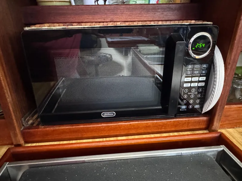 Microwave oven inside a Catalina 36 MK1 yacht kitchen, displaying time 2:54.