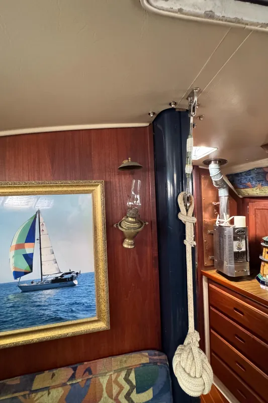 Interior of 1985 Catalina 36 MK1 sailboat with nautical decor and framed sailboat picture.