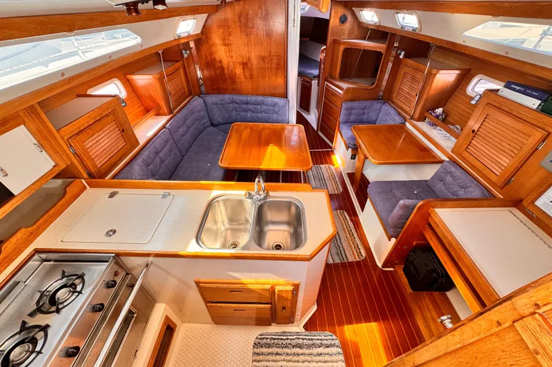 Interior of 1995 Catalina 36 MkII sailboat with wood finish and cozy seating.