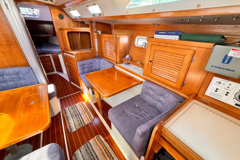 Interior of a 1995 Catalina 36 MkII sailboat with wood finish and cozy seating.