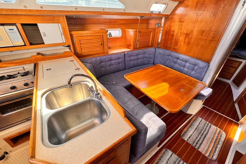 Interior of 1995 Catalina 36 MkII sailboat with kitchen and dining area.