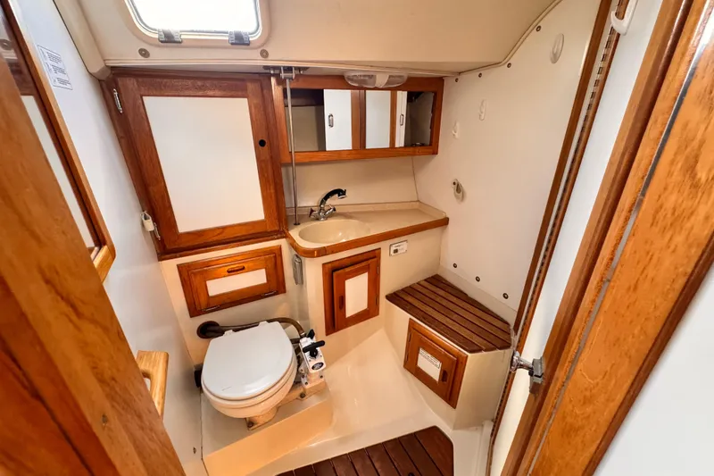 1995 Catalina 36 MkII yacht bathroom with wooden cabinetry and compact design.
