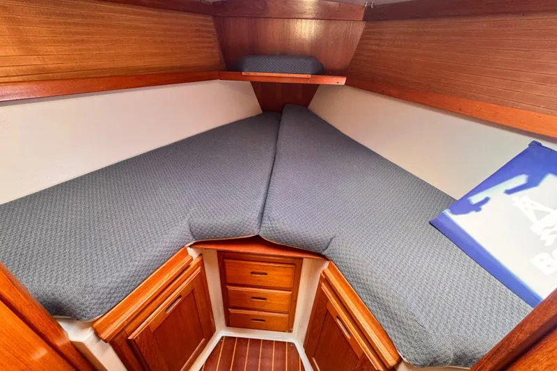 Cozy V-berth cabin in 1995 Catalina 36 MkII sailboat with wooden cabinetry.