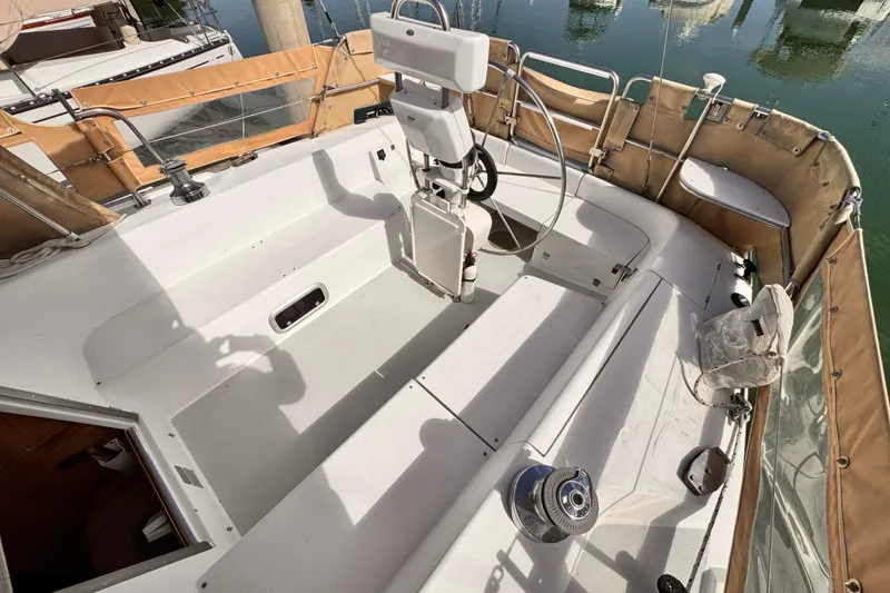 Cockpit of 1995 Catalina 36 MkII sailboat with tan canvas covers and steering wheel.