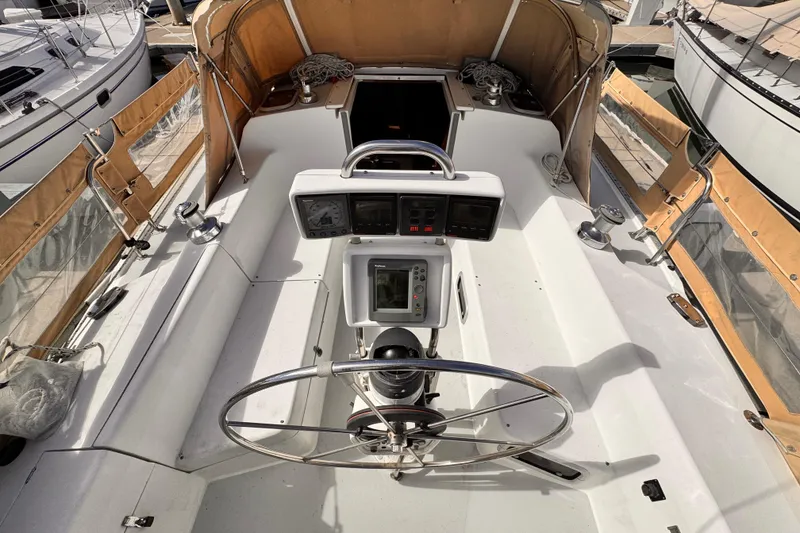 Cockpit of a 1995 Catalina 36 MkII sailboat with steering wheel and navigation instruments.