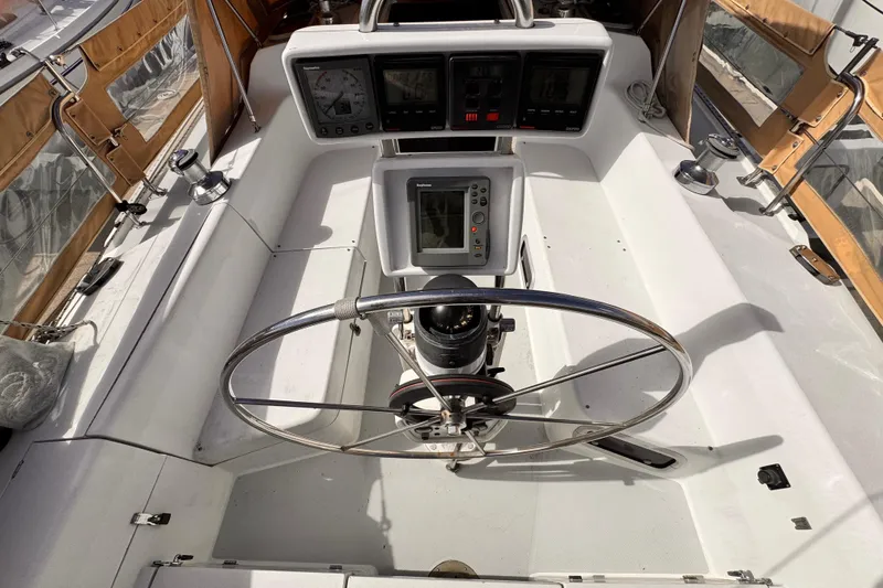 Cockpit of 1995 Catalina 36 MkII sailboat with steering wheel and navigation instruments.