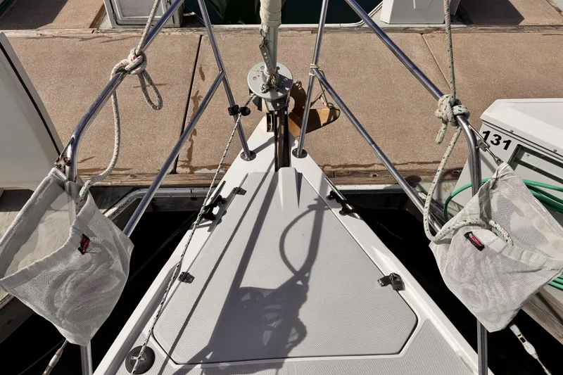 Bow of a 1995 Catalina 36 MkII sailboat docked, featuring ropes and deck details.