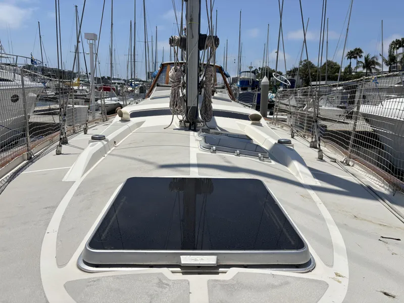 Sailboat deck view, Norseman 447, 1982 model, docked in marina with clear sky.