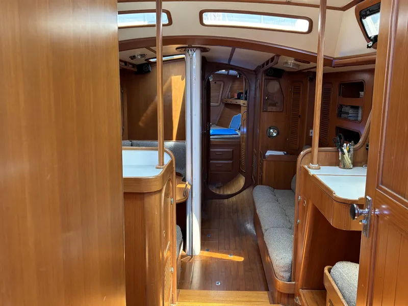 Interior of 1982 Norseman 447 sailboat with wooden furnishings and cozy seating.